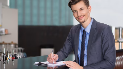 smiling-adult-businessman-writing-cafe-counter_1262-1952 smiling-adult-businessman-writing-cafe-counter_1262-1952